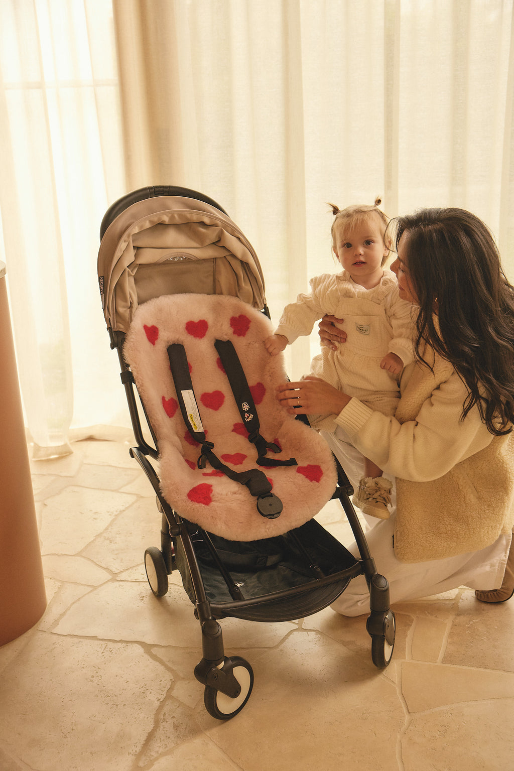 pink sheepskin pram liner with red hearts
